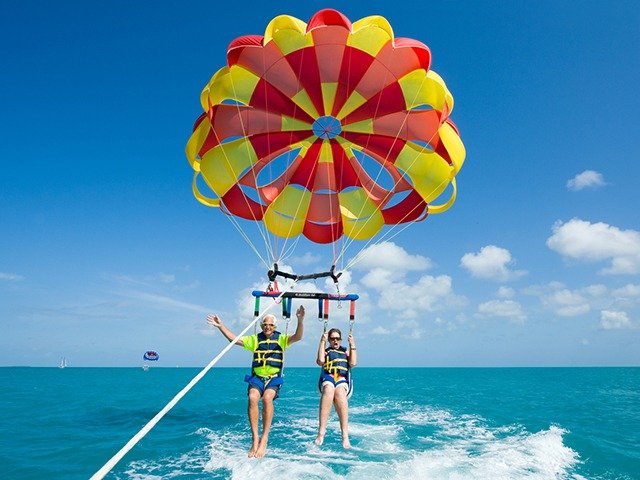 Key West, Florida, USA - May 02, 2016: An elderly couple is para sailing with a rope pulled by a boat near Key West in Florida